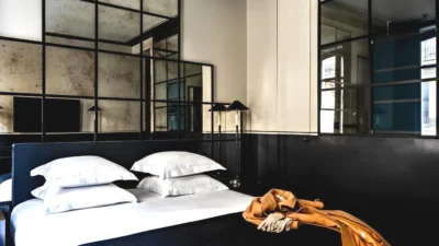 Chambre avec un grand lit avec des oreillers blancs dans Monsieur George Hotel & Spa Champs-Elysées à Paris